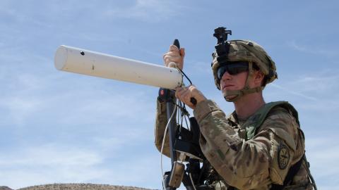 Spc. Nathaniel Ortiz, Expeditionary CEMA (Cyber Electromagnetic Activities) Team (ECT), 781st Military Intelligence Battalion, conducts cyberspace operations at the National Training Center at Fort Irwin, California, May 9. (Photo Credit: Mr. Bill Roche (Army Cyber Command))