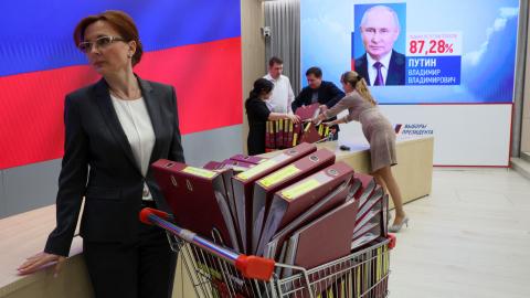 A screen displays a portrait of re-elected Russian President Vladimir Putin following the announcement of the official results in the three-day presidential election at Russia's Central Electoral Commission (CEC) in Moscow on March 21, 2024. (Stringer via Getty Images)