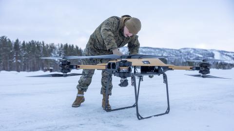 U.S. Marine Corps Lance Cpl. Andrew Hill, a motor transport operator assigned to Combat logistics Battalion 6, Combat Logistics Regiment 2, 2nd Marine Logistics Group, fastens the propeller arms on a Tactical Resupply Vehicle 150 (TRV) unmanned aircraft system during test flight operations in Setermoen, Norway, Feb. 6, 2024.   (U.S. Marine Corps photo by Lance Cpl. Christian Salazar)