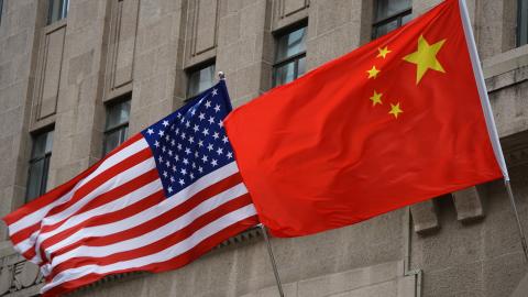 The national flags of the United States and China flutter at the Fairmont Peace Hotel on April 25, 2024, in Shanghai, China. (Photo by Wang Gang/VCG via Getty Images)