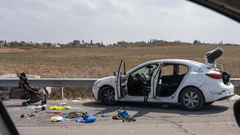 : A baby stroller, along with other personal belongings are left on the side of the road