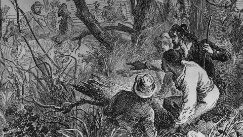 An illustration showing an escaped slave being hidden by helpers on a route using the Underground Railroad, United States, circa 1800. (Three Lions via Getty Images)