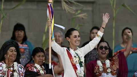 Mexico's new President Claudia Sheinbaum raises the ceremonial staff in Mexico City on October 1, 2024. (Carl De Souza/AFP via Getty Images)