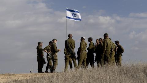 Israeli soldiers receive a briefing near the border with the Gaza Strip on December 5, 2024, in Southern Israel. (Amir Levy via Getty Images)