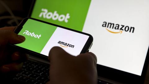 Amazon and iRobot logos are displayed on a mobile phone screen. (Yasin Baturhan Ergin/Anadolu via Getty Images)