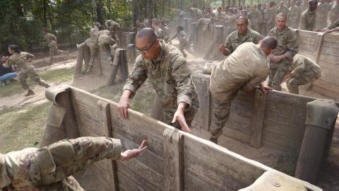 US Army trainees compete against each other on the Fit to Win obstacle course during basic training at Fort Jackson on September 28, 2022, in Columbia, South Carolina. (Scott Olson/Getty Images)