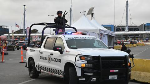 A Mexican National Guard officer stands guard on a pickup truck during a vehicle check heading to the United States at the San Ysidro Port of Entry crossing in Tijuana, Baja California, Mexico, on February 6, 2025. (Getty Images)